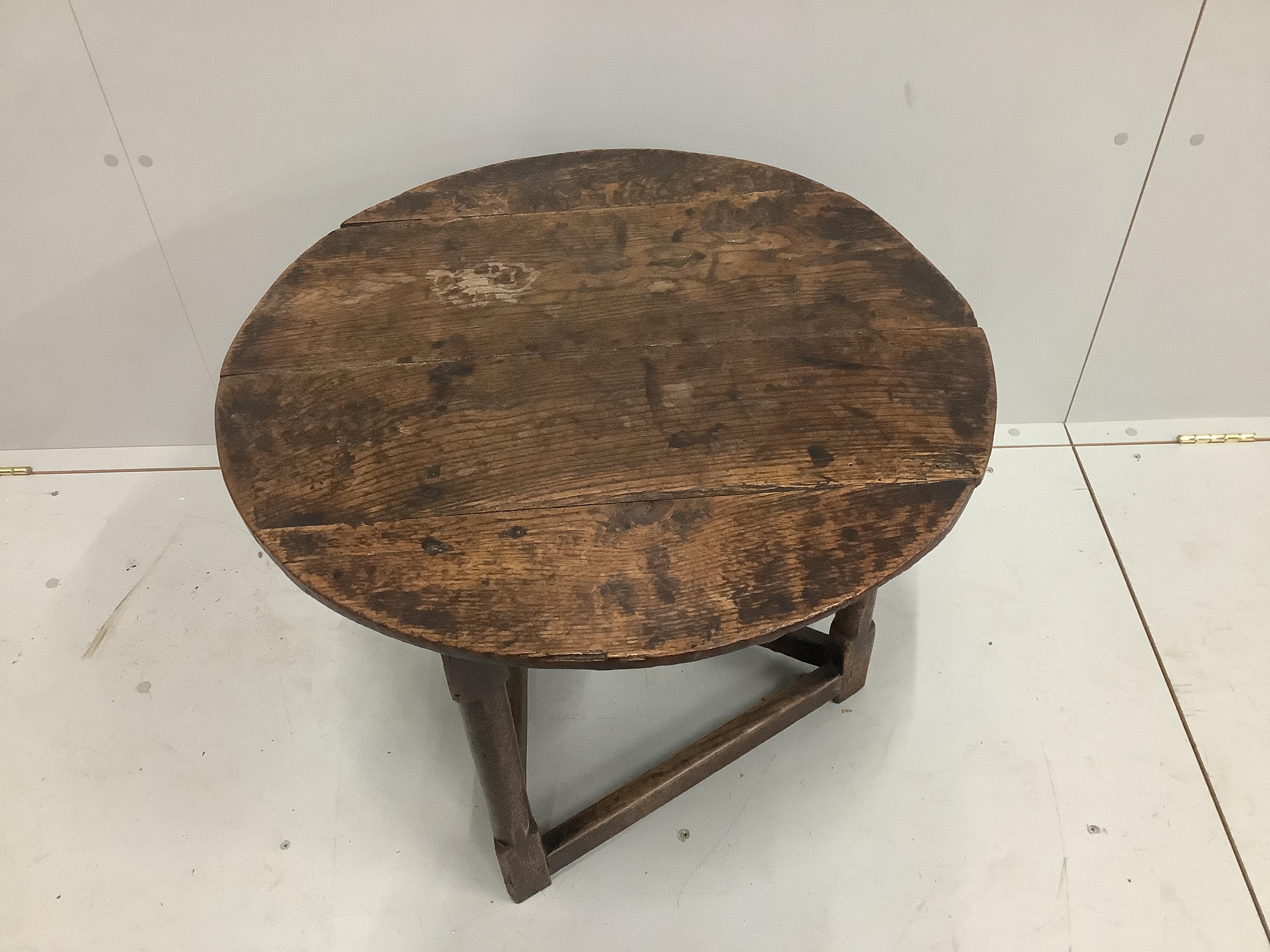 A late 18th century oak cricket table, diameter 64cm, height 55cm